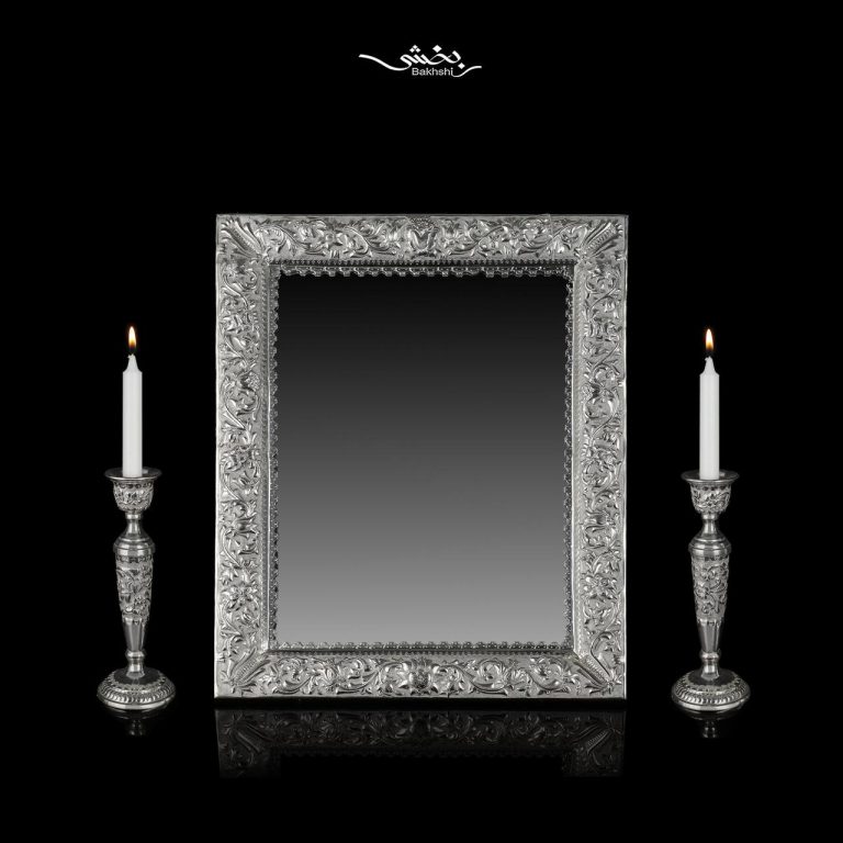 ست آینه مستطیل و شمعدان نقره تک شاخه گل برجسته ساخته شده از 1402 گرم نقره با عیار 84 درصد موجود در فروشگاه و سایت نقره بخشی.